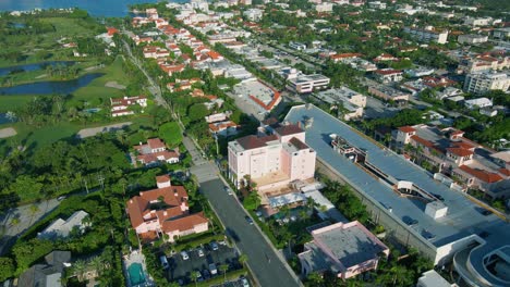 Aerial-view-around-the-Colony-hotel,-the-Everglades-golf-Club-in-the-background-on-a-sunny-morning,-in-Palm-Beach,-Miami,-Florida,-USA---orbit,-drone-shot