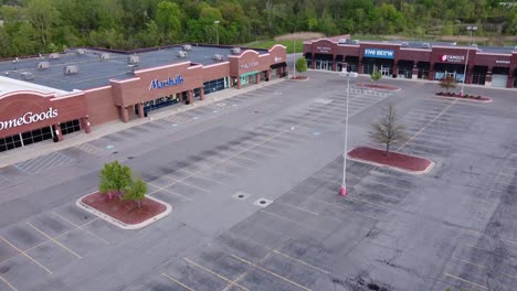 Empty-Parking-Lots-Of-Closed-Retail-Stores-Due-To-Coronavirus-Lockdown-In-Brownstown,-Michigan---aerial-drone-shot