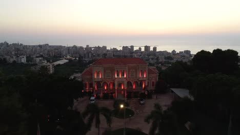 Rising-and-dolly-out-shot-of-entrance-to-stately-home---villa---mansion-revealing-extended-landscaped-city-and-luxurious-front-yard