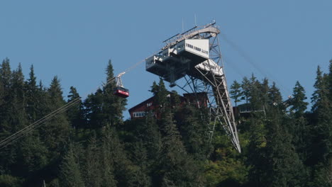 Red-Mountainside-lift-arriving-at-station-in-the-forest-in-Juneau,-Alaska