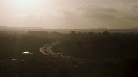 Timelapse-of-Sunset-over-Highway-with-Cars-Passing-by