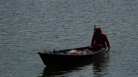 Lady-Fisher-on-her-Boat-on-Begnas-Lake,-Pokhara-Nepal