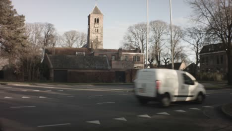 Velsen-Zuid-Netherlands---January-22nd-2019:-horizontal-pane-street-view-of-Engelmunduskerk-Oud-Velsen-church-in-a-neighborhood-during-winter-with-sunset-sunlight