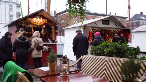 Outdoor-art-festival-with-tents,-tables-and-items-for-sale-on-cold-winter-day,-Copenhagen,-Denmark,-slow-motion