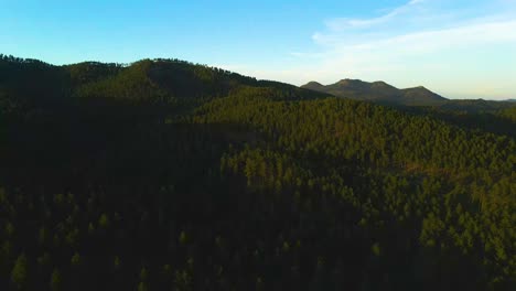 Aerial-sunset-shot-revealing-the-mountains-filled-with-ponderosa-pine-trees-in-the-Black-Hills