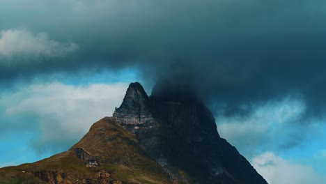 Insane-timelapse-of-Otertinden-in-Northern-Norway,-clouds-hugging-the-top-hiding-the-main-pillar