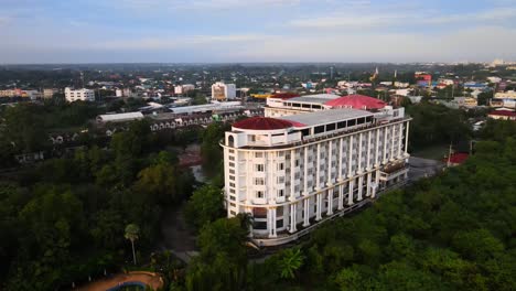 Drone-Footage:-An-Old-Abandoned-Colonial-Style-Hotel-by-the-Lake-surrounded-by-Trees-at-Dawn