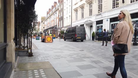 Man-walking-in-London-Street-then-two-girls-walk-into-shot