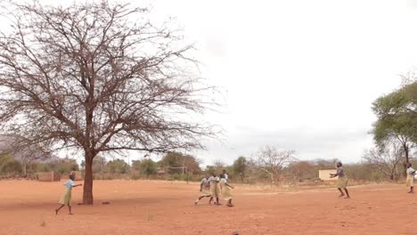 School-girls-playing-football-in-a-dry-area,-Kenya-Africa