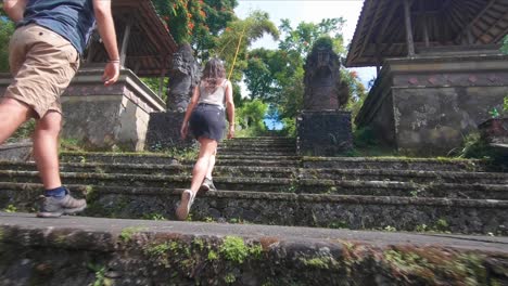 Low-angle-view-of-tourists-visiting-a-temple-in-Bali,-Indonesia