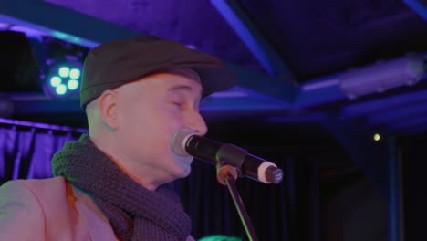 Closeup-of-Caucasian-senior-man-singing-at-Christmas-celebration