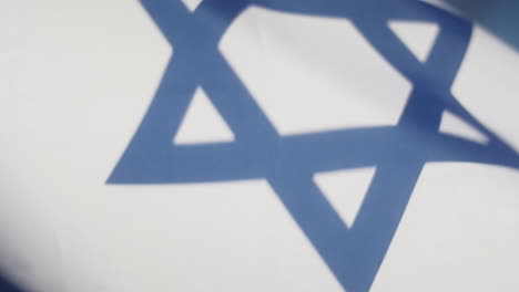 Extreme-Close-Up-of-Jewish-Star-of-David-on-Israel-Flag-as-it-Waves-in-Slow-Motion