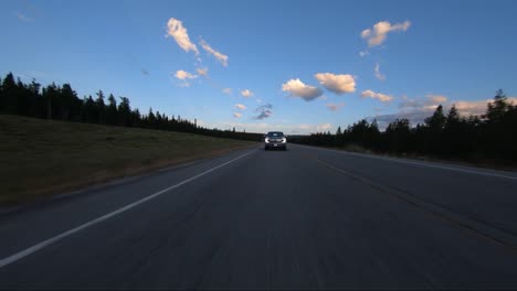 A-low-drone-pass-over-top-of-the-truck-driving-down-the-road