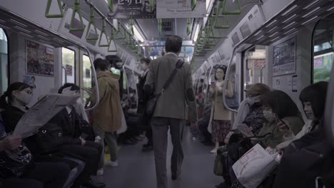 Slow-motion-shot-of-Japanese-people-driving-with-train-in-Tokyo,Japan