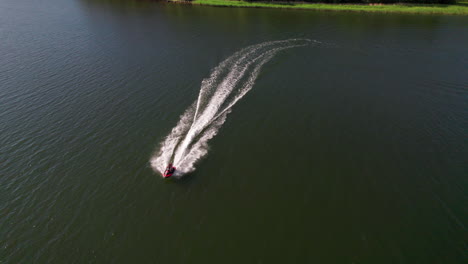 Aerial-of-jet-ski-on-water-speeding-in-Nordic-archipelago,-drone,-Sweden