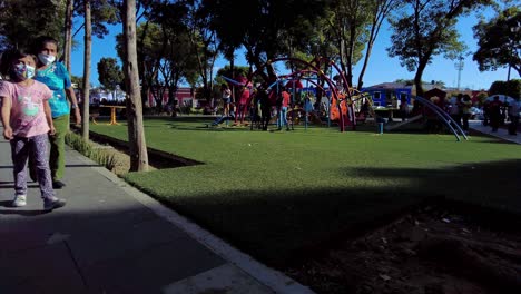 People-gathering-and-playing-in-the-park-at-the-downtown-city-square-wearing-masks-during-the-pandemic