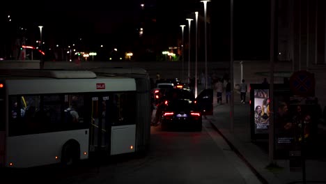 Public-transport-bus-ride-and-stop-at-bus-station-at-evening-in-Tirana