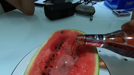 Pouring-beer-into-watermelon-and-having-fun-in-Ho-Chi-Minh-City,-Vietnam