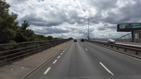 POV-Driving-Along-The-A312-Parkway-Dual-Carriageway-And-Approaching-Flyover-On-Sunny-Day-In-May-2022