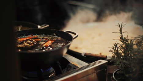 Traditional-Estonian-food-prepared-in-deep-frying-pan-and-big-caldron-at-the-Christmas-Market-in-Tallinn,-Estonia