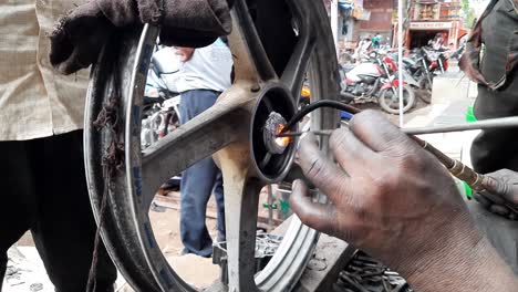 A-welder-making-a-bearing-seat-on-alloy-wheel-by-aluminum-gas-welding