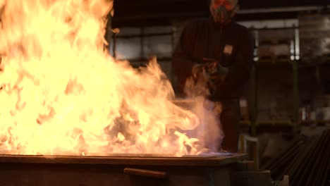 Worker-with-a-flamethrower-working-on-a-refractory-mold