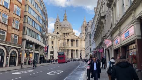 Red-double-decker-bus-driving-on-street-towards-St-Pauls-Cathedral-in-London