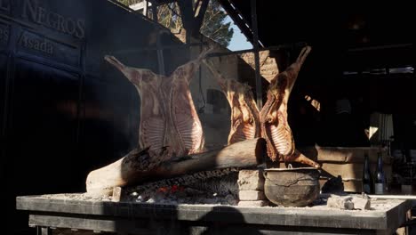 Roasted-goat-prepared-in-a-typical-argentinian-grill-near-fire