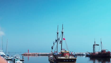 Boy-on-board-watching-a-touristique-pirate-Boat