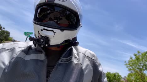 Rider-wearing-protective-helmet-riding-motorcycle-in-residential-area