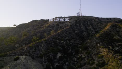 Aerial-view-rising-towards-the-Hollywood-sign,-sunny-evening-in-Los-Angeles,-USA