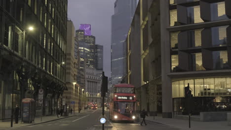 Quiet-Early-Morning,-Queen-Victoria-Street-Looking-Towards-Bank-Station,-Commuters-Walking-and-Cycling-to-Work,-and-London-Bus,-Bank-of-England-and-8-Bishops-Gate-Looming-in-Background