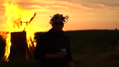 Relaxed-person-dancing-near-bonfire-in-the-sunset