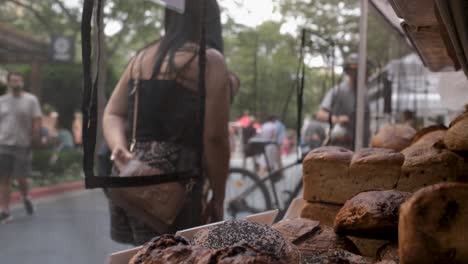 Two-ladies-shopping-for-ecological-bread-at-farmer's-local-street-market