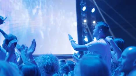 Young-man-is-feeling-the-good-vibes-and-dances-in-the-crowd-at-a-party