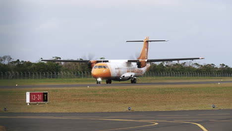 Air-Calédonie-propeller-airplane-taxiing-to-runway,-preparing-for-takeoff