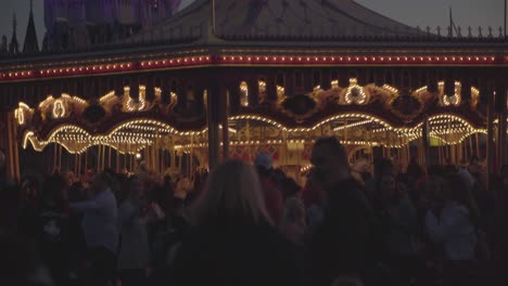 Merry-Go-Round-in-a-theme-park-with-many-people-at-dawn