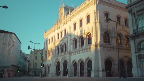 Lisbon-city-empty-downtown-old-buildings-ornamented-facade-traffic-lights-closed-stores-at-sunrise