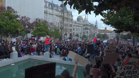 Porto-Portugal---june-6th-2020:-BLM-Black-Lives-Matter-Protests-Demonstration-man-adresses-the-cheering-crowd-with-a-microphone-in-his-hand-wide-angle