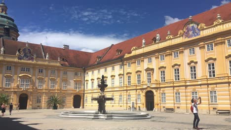 Pralatenhof-courtyard-in-Stiff-Melk-Castle-with-tourist-taking-a-picture