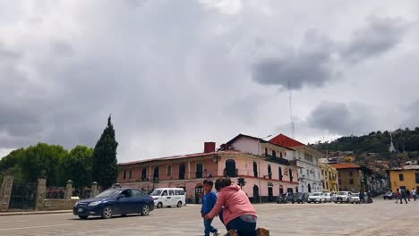 San-Francisco-Church-In-Cajamarca,-Peru-With-People-And-Traffic-On-Busy-Street-At-Daytime