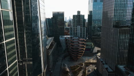 Aerial-view-tilting-towards-the-vessel-structure,-in-sunny-Hudson-Yards,-New-York