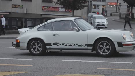 Slow-motion,-classic-vintage-Porsche-Carrera-911-driving-on-street