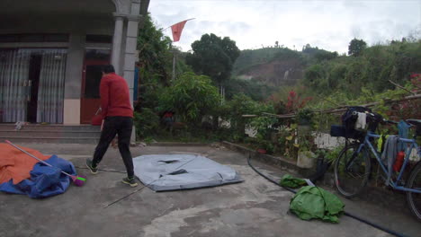 Time-lapse-of-two-vietnamese-men-building-a-camping-tent-during-the-day