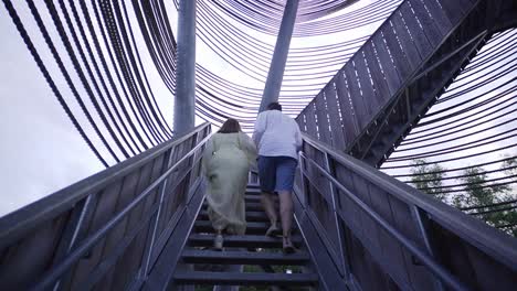 Couple-walking-up-the-stairs-of-the-sahara-tower-in-Belgium