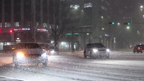 Cars-and-traffic-driving-on-highway-at-night-in-heavy-snow,-Seoul-South-Korea