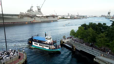 Aerial-View-Of-Steamboat-Coming-Into-Dock-Opposite-General-Dynamics-Nassco-Shipyard