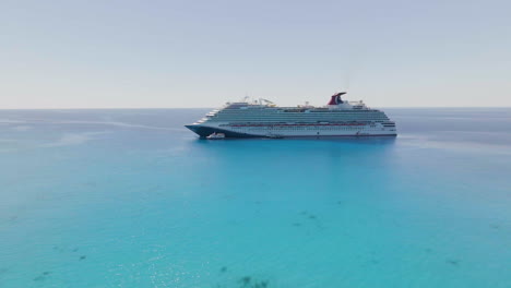 Aerial-view-approaching-the-Carnival-dream-cruise-ship-anchored-in-shallow-waters-of-Bahamas