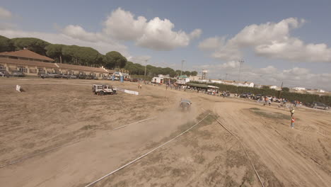 FPV-drone-orbits-Land-Rover-on-sandy-Iberlince-off-road-race-course