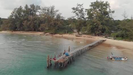 Aerial-forward-at-Lazy-beach-wooden-jetty